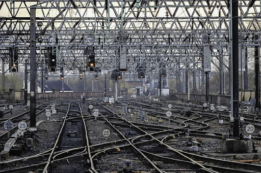 A very complicated layout of railway tracks with multiple signs and signals